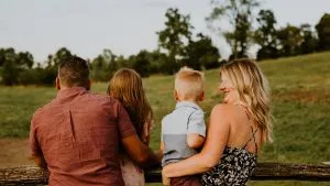 Libby Ward and family look into the distance outside in a green field