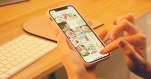 A hand scrolls instagram with images seen on the screen
