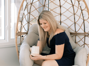 Libby Ward Diary of an Honest Mom holding a coffee mug sitting in a comfortable chair